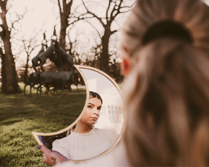 Woman Reflecting on Inner State in Mirror